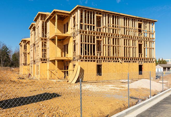 a close-up of temporary chain link fences enclosing a construction site, signaling progress in the project's development in Hamburg, NY